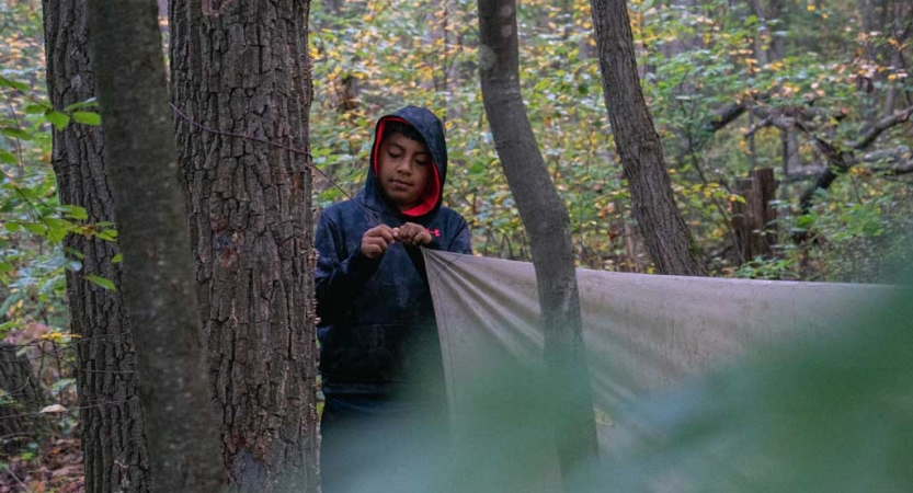 a student assembles a shelter on a backpacking trip for teens near DC